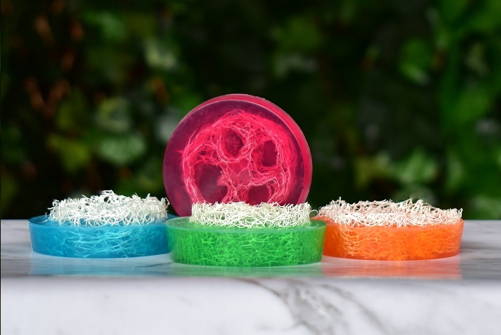 Clear loofah soap on white and green background